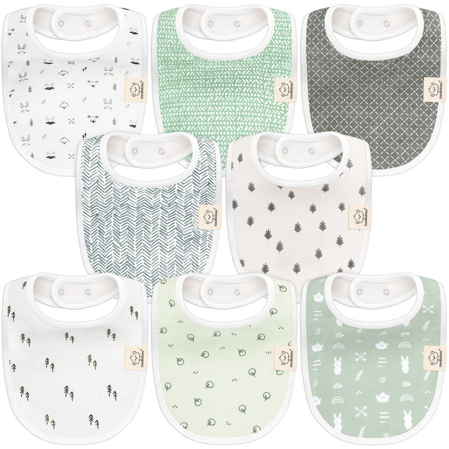 A set of eight classic baby bibs with a mix of green and white tones, featuring minimalist nature patterns like trees, leaves, and geometric designs, made from soft, absorbent fabric.
