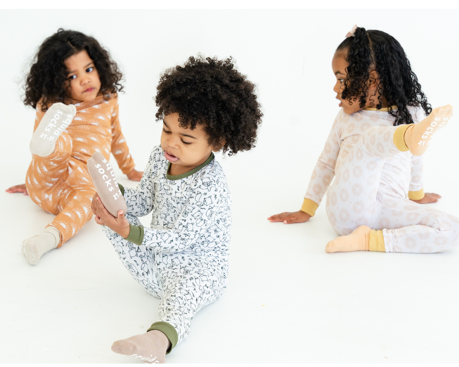 Three children wearing bamboo bundle products with promotional text on a white background