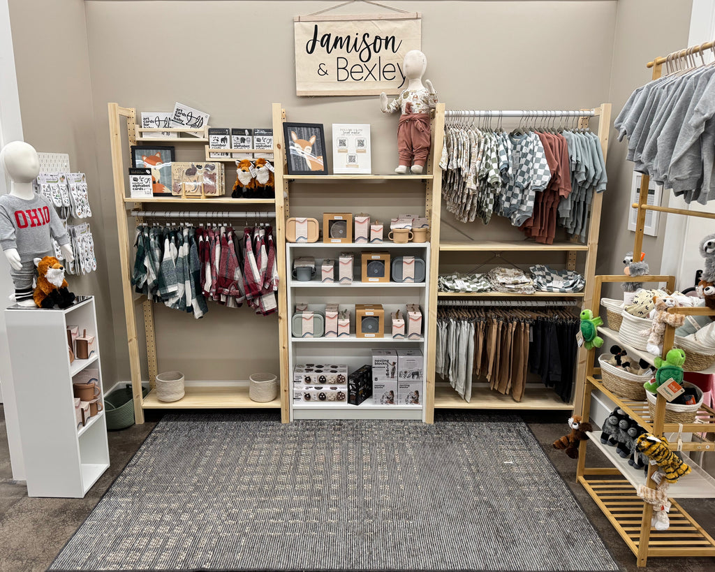 Children's clothing store with shelves and racks displaying various items.
