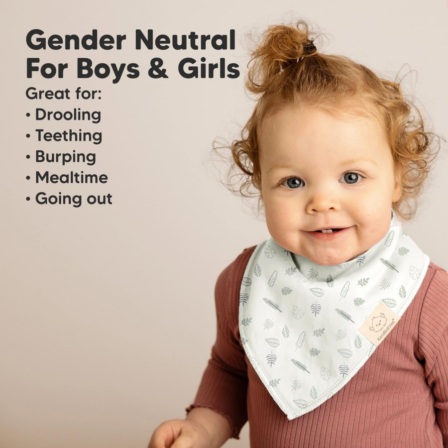 A toddler wearing a soft, gender-neutral bandana bib in a light green leafy pattern. The text on the image highlights the bib’s versatility for drooling, teething, burping, mealtime, and outings.